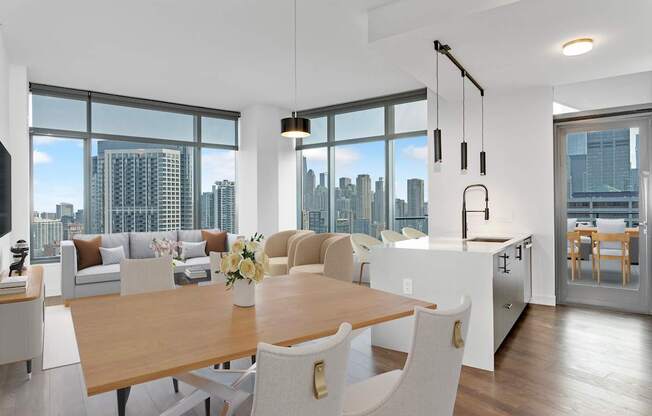 a living and dining room with a city view and a table and chairs at Cassidy on Canal, Chicago