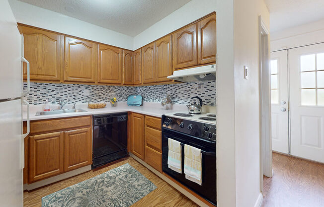 a kitchen with black appliances and wooden cabinets