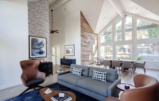 A living room with a grey couch and a brown chair.