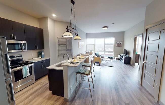 A kitchen with a dining table and chairs.