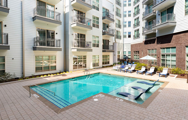 a swimming pool in front of an apartment building