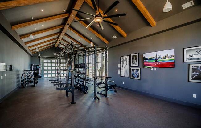 A room with a ceiling fan and pictures on the wall.