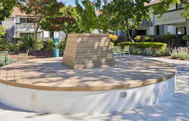 A small round pool with a bench and a wall around it.