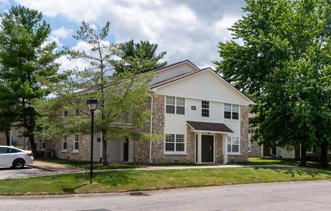 a white house with a car parked in front of it