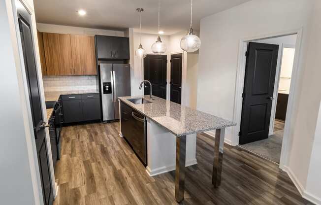 a renovated kitchen with a marble counter top in a new home