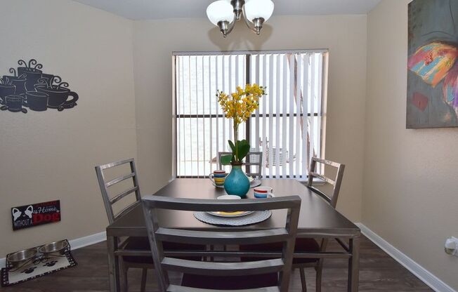 a dining room with a table and chairs