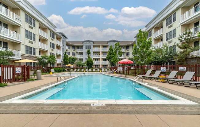 a swimming pool with an apartment building in the background at Pier Village Apartments, New Jersey, 07740