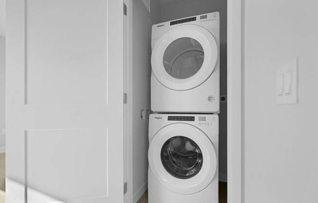 a washing machine and a dryer in a white closet