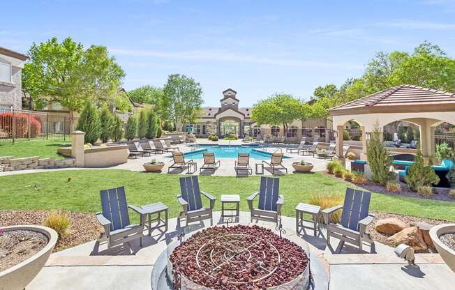 an outdoor patio with chairs and a pool