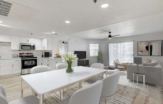 A modern kitchen with a dining table set for four.