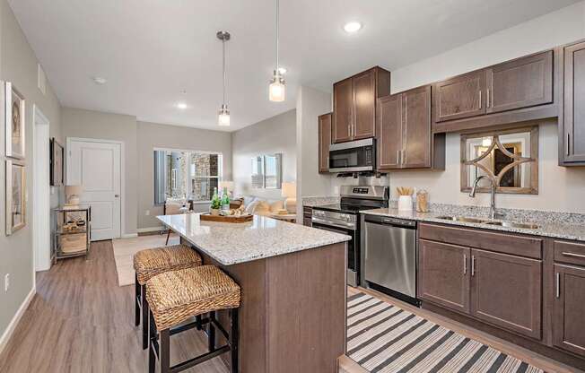 A kitchen with brown cabinets and a white island.