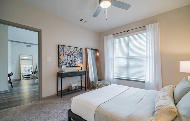 a bedroom with a large bed and a ceiling fan at Creekside at Legacy, Plano, Texas 75024