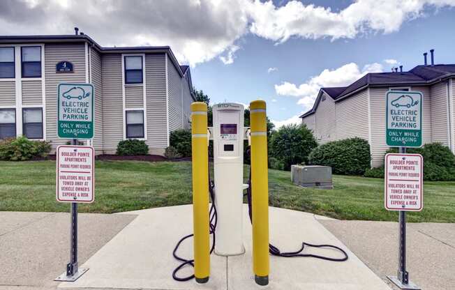 a white and yellow gas pump with two signs in front of it