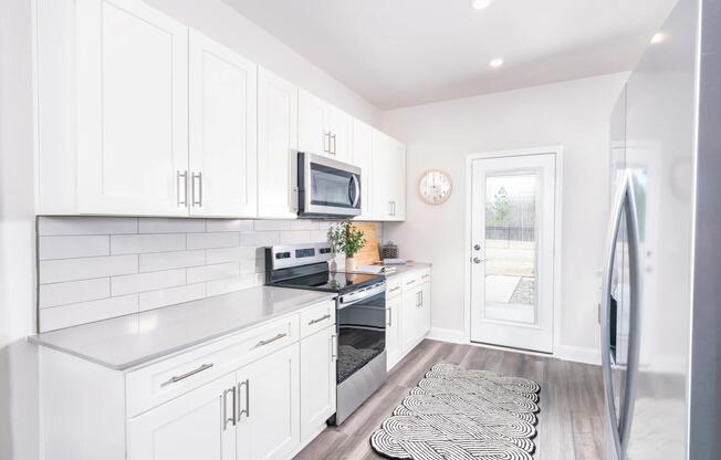 Creating culinary magic in this spacious kitchen complete with stainless steel appliances.
