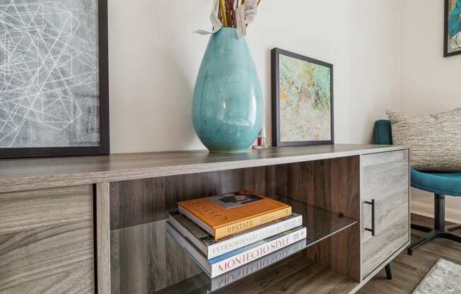 a console table with a vase and books on it