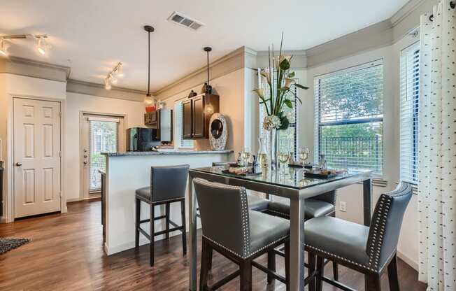 a kitchen with a bar and a table with chairs