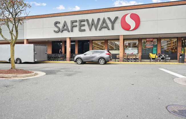 A Safeway store with a car parked in front.