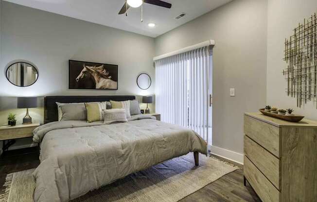 bedroom with bed and night stands with large window at Echo Park at Perry Crossing Apartments, Plainfield