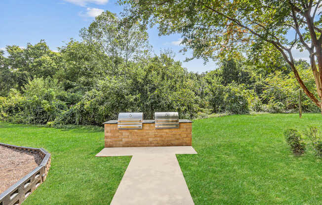 A backyard with a hot tub and a concrete walkway.
