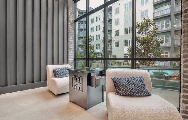 a living room with a couch and a table in front of a window