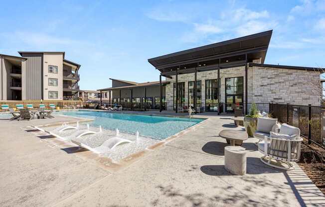 A modern building with a pool in front. at Bridge at Tech Crossing, Austin, Texas