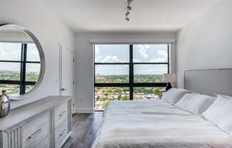 Two Bedroom Apartments in Miami FL - MB Station - Bright Bedroom with Grey Hardwood Flooring and a Large Side Window