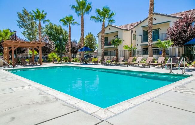 High Desert CA Apartments - Riverton of the High Desert - Gated Pool Surrounded by Lounge Seating