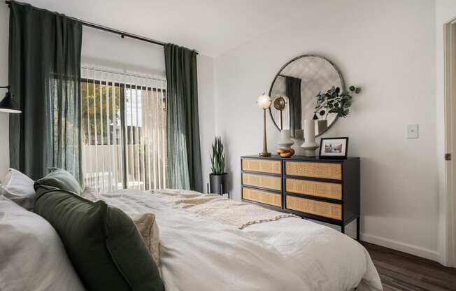 a bedroom with a bed and a dresser and a window