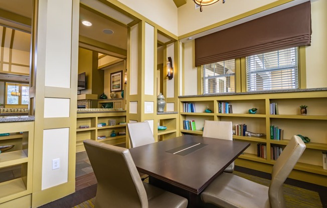 meeting room with a table and chairs and bookshelves