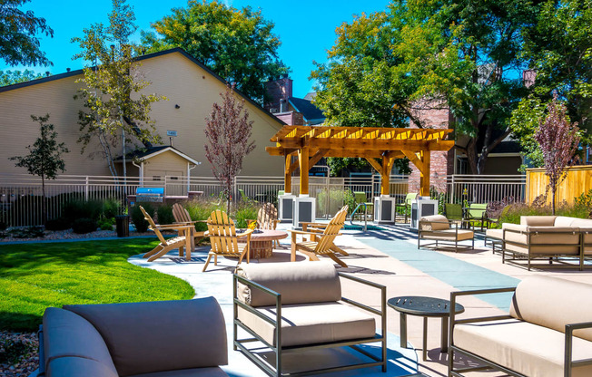 a patio with chairs and tables and a gazebo at Skyview Apartments, Westminster Colorado 