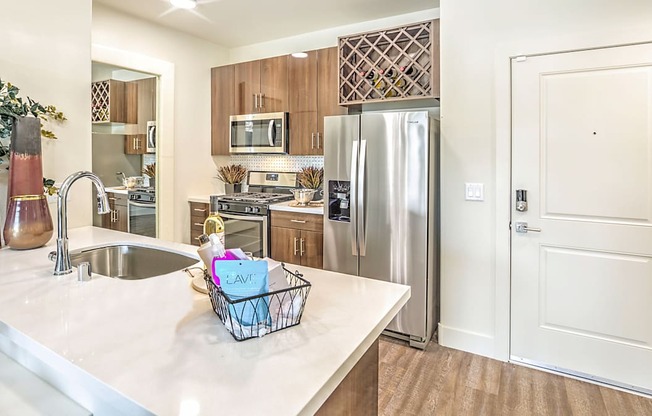 a kitchen with stainless steel appliances and a counter top with a basket on it