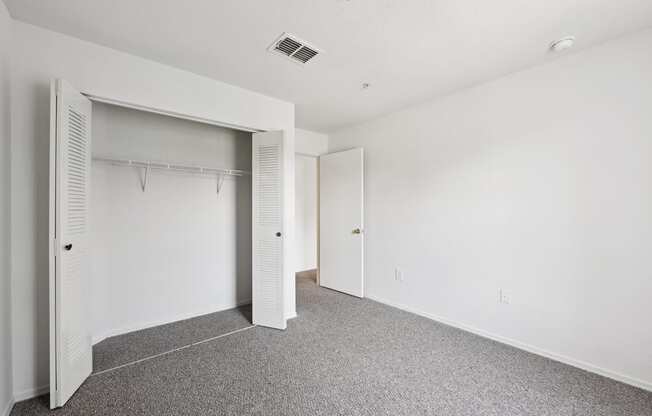 a row of closet doors in a white room