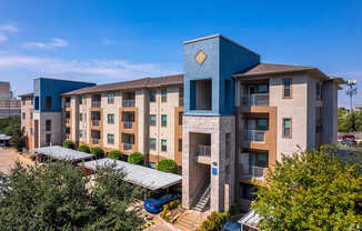 A modern apartment complex with a blue building in the foreground.