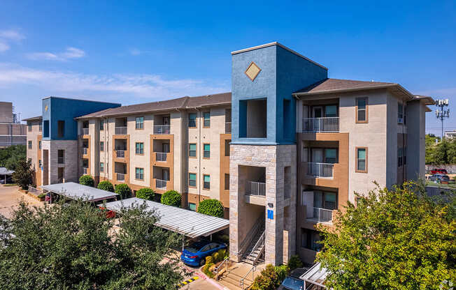 A modern apartment complex with a blue building in the foreground.