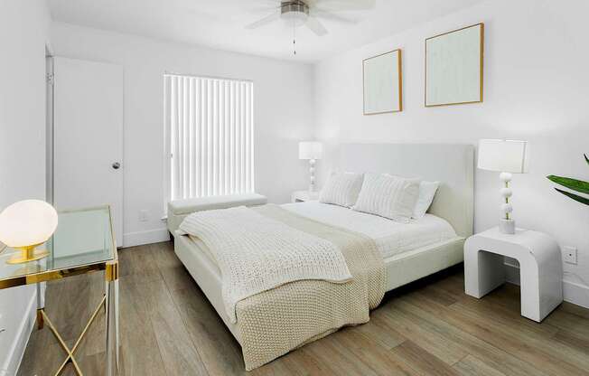 A bedroom with a bed, nightstand, and a ceiling fan.