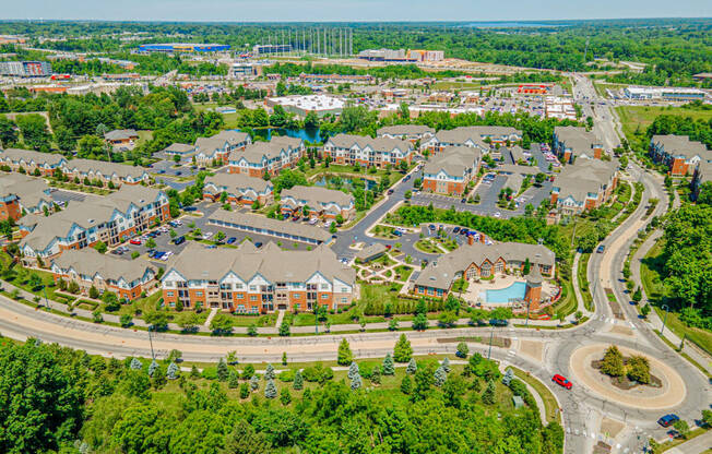 an aerial view of a suburb of a city with houses and roads
