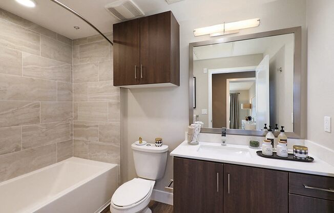 a bathroom with a sink toilet and a mirror