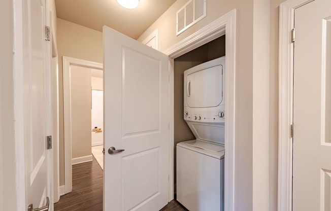 A white door is open to reveal a white dishwasher.