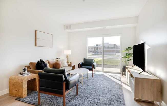 A living room with a black leather chair and a wooden side table.