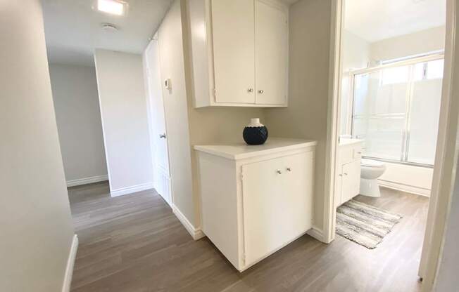 a renovated bathroom with a white cabinet and a toilet