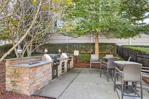 a patio with a hot tub and tables and chairs