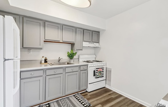 a white kitchen with white appliances and white cabinets