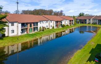 an apartment complex with a river in front of it