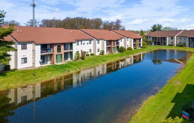an apartment complex with a river in front of it