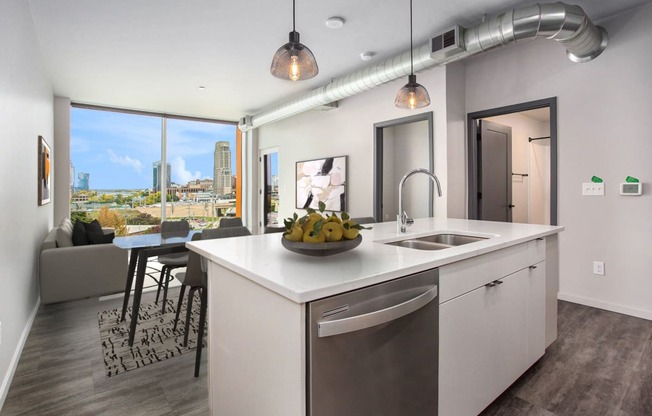 an open kitchen and living room with a view of the city