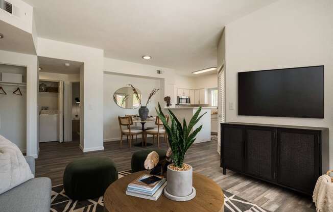 a living room with a tv and a table with chairs