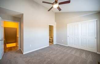 an empty living room with a ceiling fan and a door to a bathroom at Traditions at Slate Ridge, Ohio
