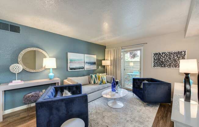 Living Room with Window,  Hardwood Inspired Floors, White Carpet, Blue Suede Chair, White Sofa, Lamps