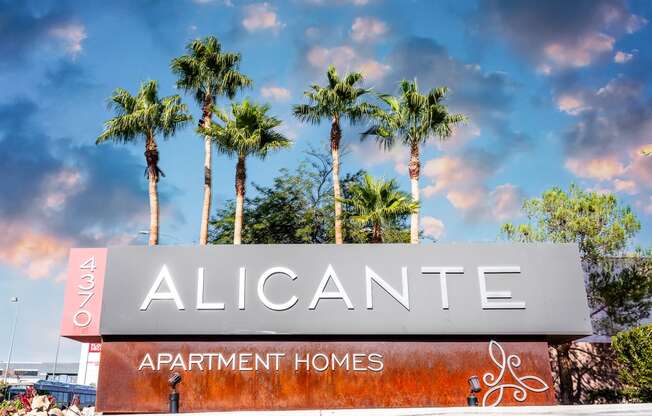 a sign for alicante apartment homes with palm trees