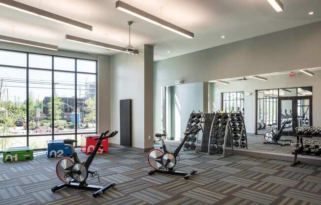 a gym with weights at Tinsley on the Park apartments